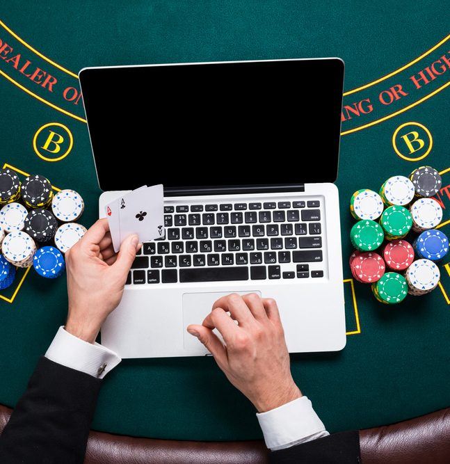 man playing blackjack on laptop